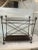 Beautiful magazine rack with rope and tassel detail in a dark metal finish. A great Hollywood Regency look that would also...