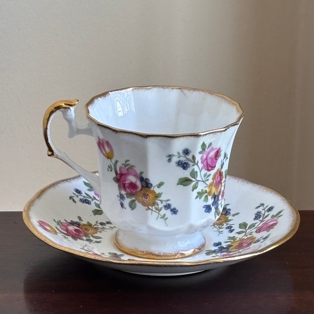 Offering a lovely vintage Elizabethan Fine Bone China teacup and saucer set made in England. This elegant set features...