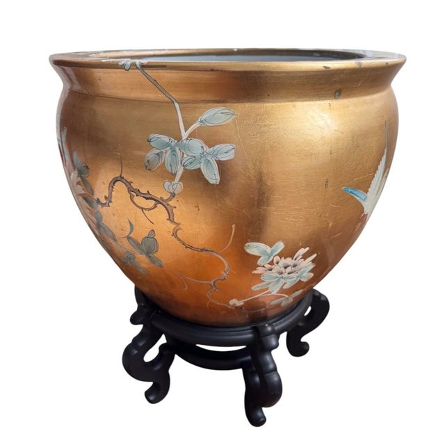Fabulous pair of large Chinese gold lacquered fish pots featuring hand-painted floral & bird designs on the exteriors....