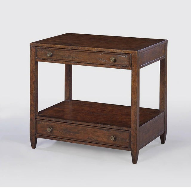 A wide rectangle side table with two drawers, brass hardware, and tapered feet, with a “country” dark mahogany tone with...