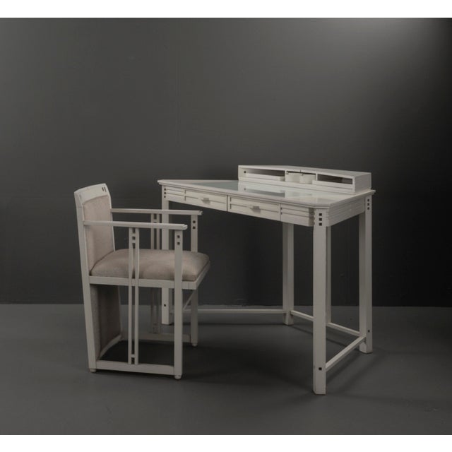 Desk with matching armchair from the “Galaxy” series, dating to the 1980s. The set features a clear, architectural design...