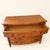 An Ethan Allen bowfront chest in warm pine, its four drawers framed by faux-bamboo turned columns and bamboo-carved...
