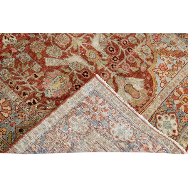 Beautiful antique Bakhtiari hand-knotted wool rug with a red field. This piece rug has a blue frame with multicolor...