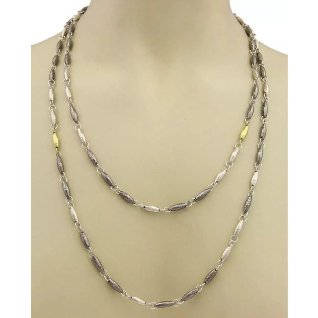 Material: sterling silver & 24k gold Measurement: 50" long and 4.5mm wide x 4mm high Weight: 82.8 grams Retailed for:...