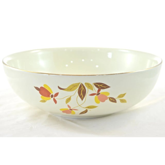 Large vintage round bowl with a gold rim and yellow, red, and brown leaf vine pattern. Maker's mark on underside. Light wear.