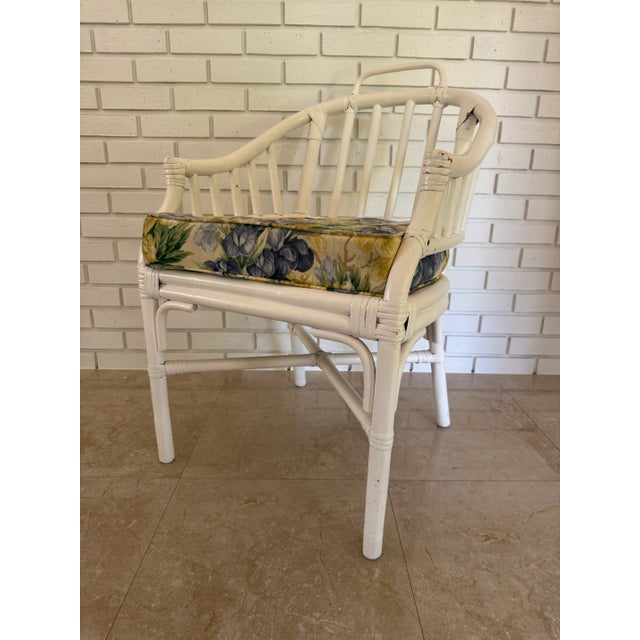 Bring a touch of mid-century coastal charm home with this elegant 1960s white rattan chair in the McGuire style. Featuring...