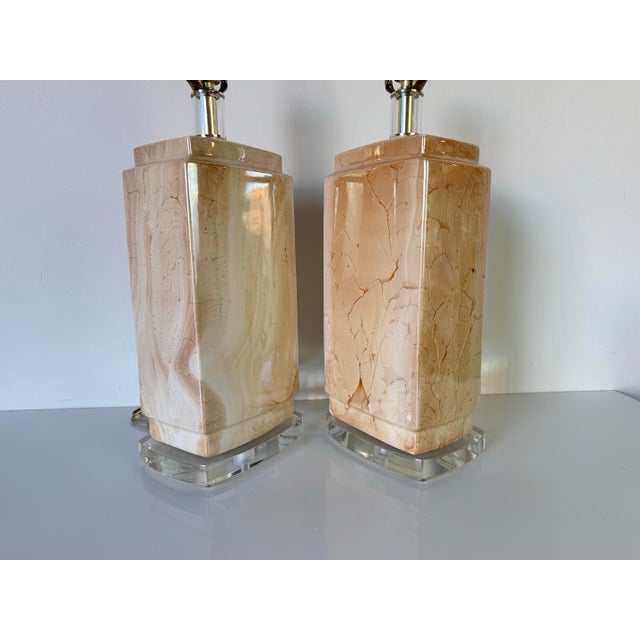 Add a touch of classic elegance to your space with this stunning pair of 1980s vintage ceramic table lamps by Bauer Lamp...