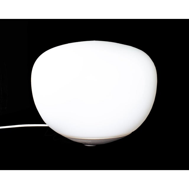 A "Jonisk" lamp designed by the Swedish designer Carl Öjerstam for Ikea. This lamp features an orb-like shape which rests...