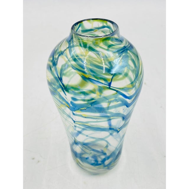 This hand-blown art glass vase is signed and dated 1975 by American glass artist Roland R. Correia. It features soft...