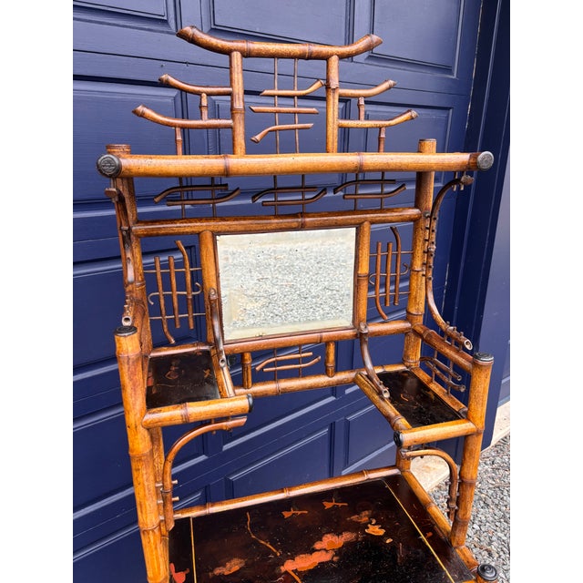 An exquisite Asian influenced Bamboo Etagere, probably of English origin, circa 1860-80, with a pagoda top and inset...