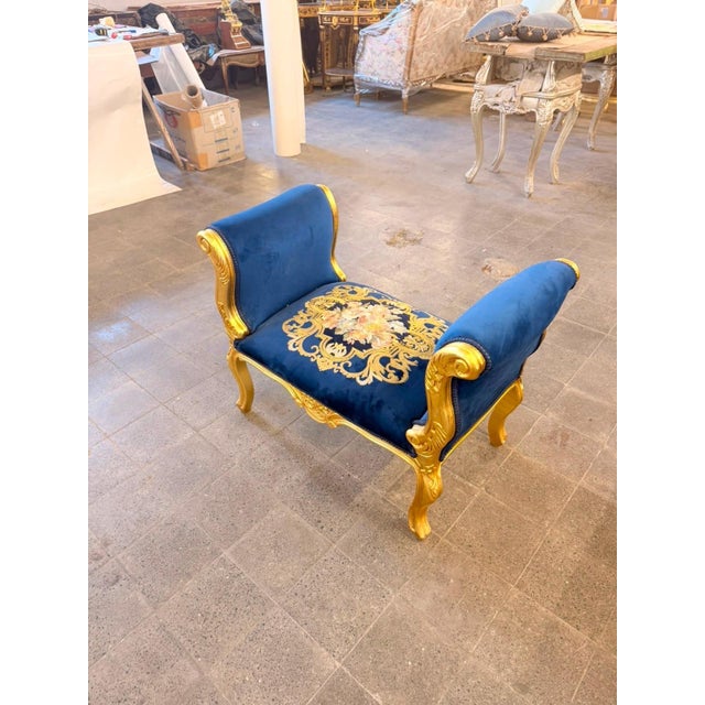French Louis XVstyle double-ended bench / window seat, upholstered in rich royal blue velvet and framed in an ornate gold...