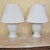 Pair of vintage American-made white ceramic ginger jar table lamps featuring raised floral relief decoration, glossy white...