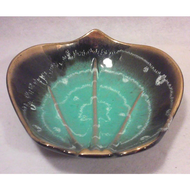 Mid-Century German turquoise and black decorative ceramic dish with 24k gold trim. This vintage dish has a cool shape and...