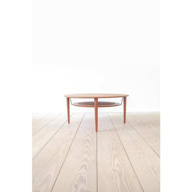 The coffee table model FD-515 (made of teak wood, a wickerwork shelf and very lovely brass elements) was designed by Peter...