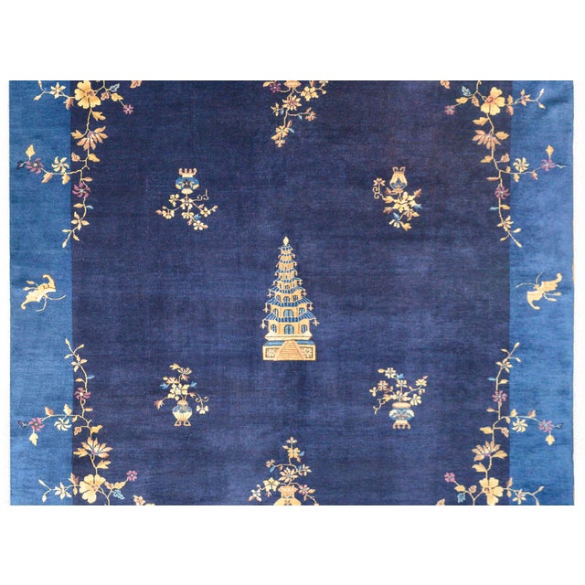 An outstanding early 20th century Chinese Art Deco rug with a large pagoda in the center amidst a field of potted...