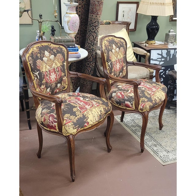Find an elegant pair of French vintage parlor chairs with tapestry upholstery. Each features Louis the 15th frames in...