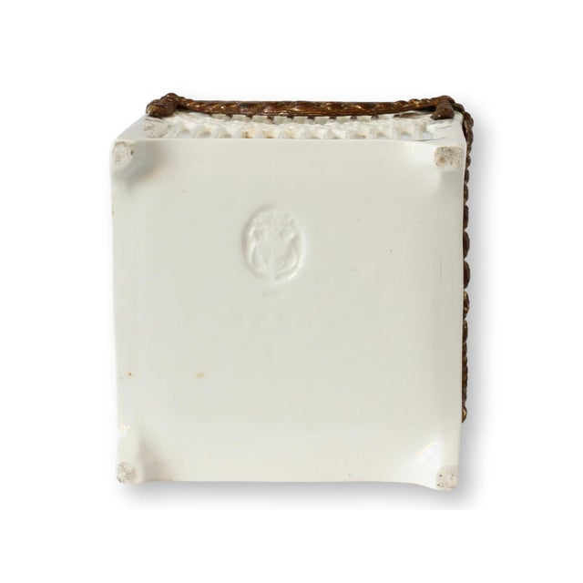 Charming Max Roesler creamware basket cache pot, featuring delicate brass embellishments that add a touch of elegance to...