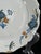 An authentic 18th-century French faience plate from La Rochelle, finely hand-painted in soft polychrome enamels with a...