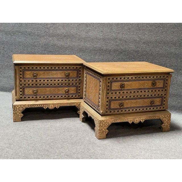 A striking pair of handcrafted nightstands featuring exceptionally detailed carved decoration throughout. Each stand is...