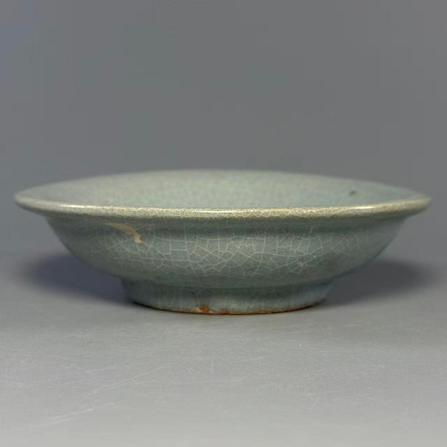 This antique Chinese shallow dish is covered in pale celadon glaze with fine natural crackle texture. Simple elegant...