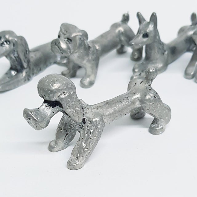 6 pewter table knife rests in the form of 6 different dog breeds. Made by Les étains de la fontaine, Paris and stamped...