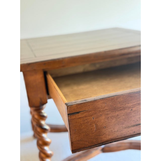 Substantial vintage side table with beautifully turned barley twist legs, scrolling stretcher base, and rich walnut toned...