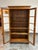 Design Plus Gallery presents a Vintage Display Cabinet. The display cabinet has a wood frame with glass-paneled double...