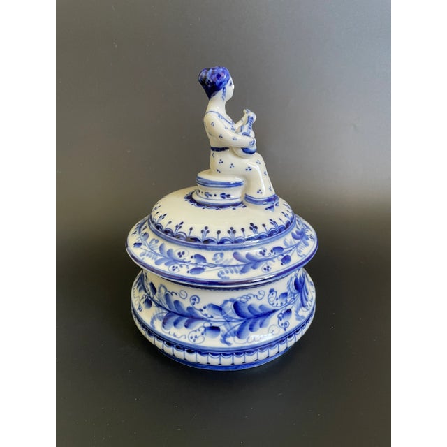 Vintage USSR Gzhel Porcelain Lidded Trinket Box w/ Lady playing Russian guitar finial. Hand painted statement piece by...