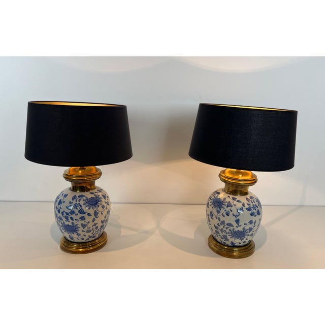 This very beautiful and fine pair of table lamps is made of porcelain in blue and white tones with Chinese decorations on...