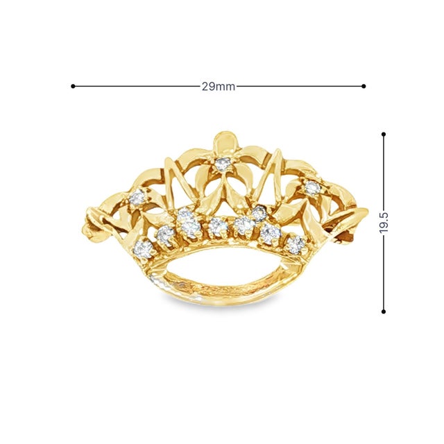 This mid-century brooch is crafted in 14k yellow gold. The design features an ornate crown motif with intricate openwork...