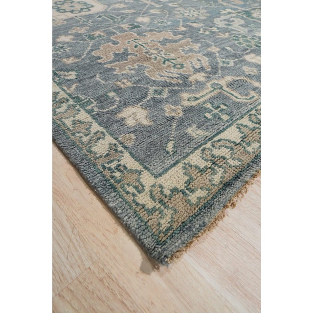 Beautiful Oushak Blue Hand Knotted Wool Rug, Country of Origin: India. This exquisite piece captures the grand scale and...