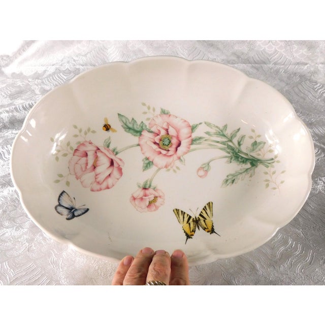 This is a large oval serving bowl by Lenox in the Butterfly Meadow pattern from 1999. The inside of the bowl has large...