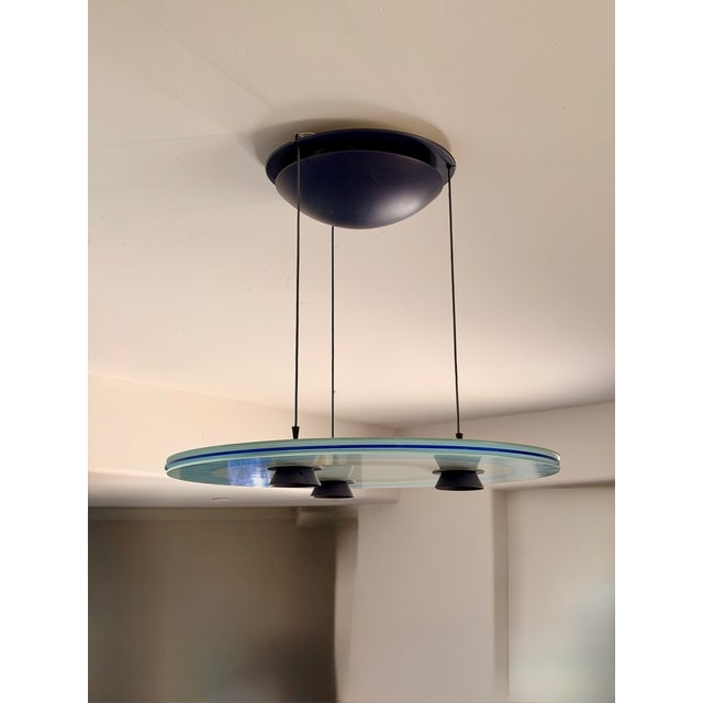 The "Aurora" pendant light for Arteluce, a division of Flos, was designed in 1980 by Perry King and Santiago Miranda. The...