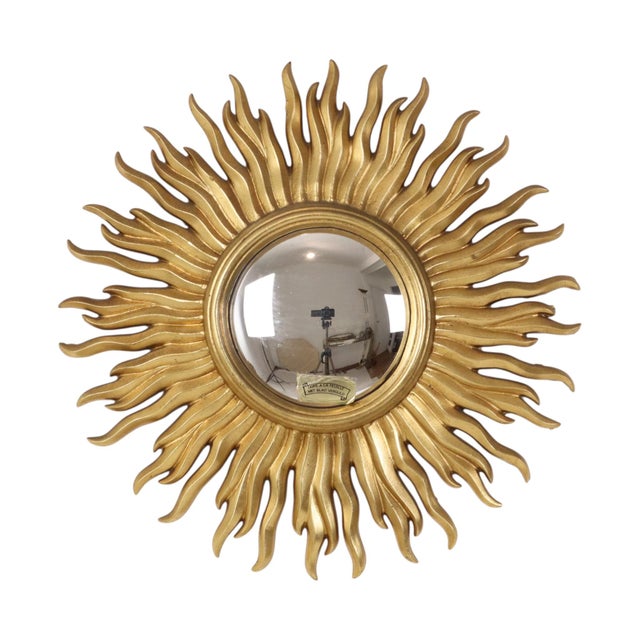 A beautiful vintage gold sunburst mirror featuring convex glass; the frame is made of resin gilded with gold leaf. Origin:...