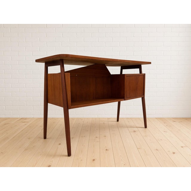 Gunnar Nielsen designed a family of teak desks, secretaires, and case pieces for Tibergaard in the 1960s. This compact...