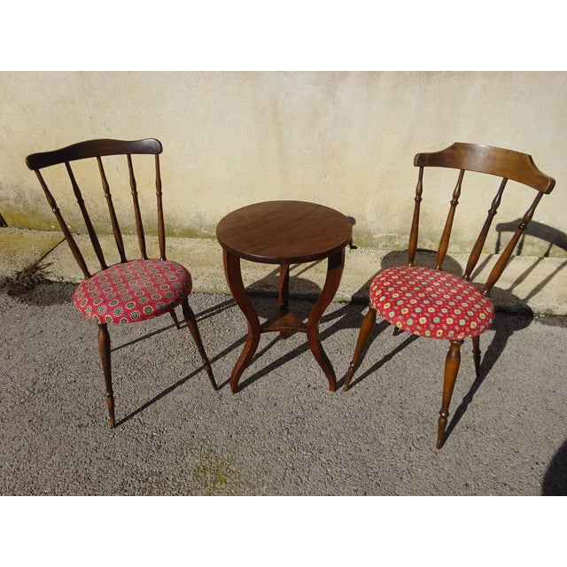 Pair of nearly identical chairs, made of solid beech with a dark oak stain. Fan-shaped spindle backrest with a curved...