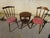 Pair of nearly identical chairs, made of solid beech with a dark oak stain. Fan-shaped spindle backrest with a curved...