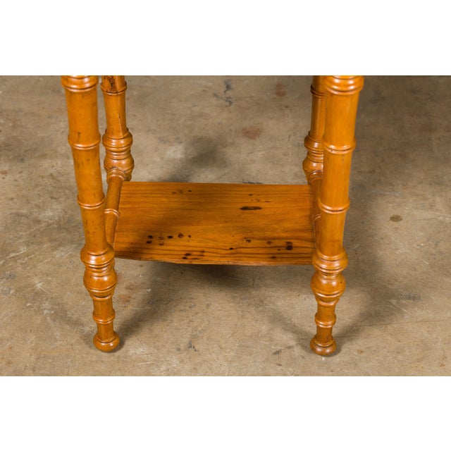 A French faux bamboo pine side table from the 19th century with white marble top, single drawer as well as door and lower...