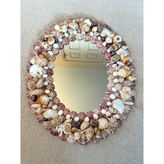Beautiful vintage handmade shell encrusted oval wall mirror. This piece was crafted by hand with each shell applied...