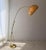 1970s arc lamp by Hustadt Leuchten, crafted in brass with a large semi-transparent cocoon shade. The tall, curved arm...