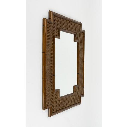 Midcentury beautiful wall mirror in bamboo, rattan and wicker in the style of Vivai Del Sud. Made in Italy in the 1970s....