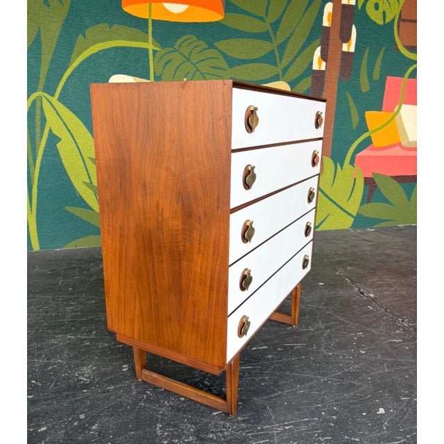 Really unique and well-made mid century Stanley tallboy here. Walnut case, white drawer fronts, brass spade pulls, and...