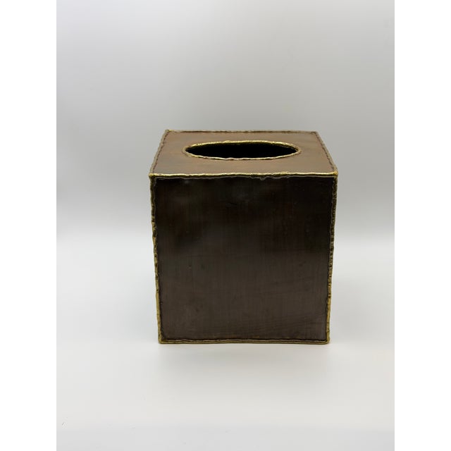 Beautiful vintage artisan metal tissue box cover featuring a warm copper-brown finish with raised brass edging. The bottom...