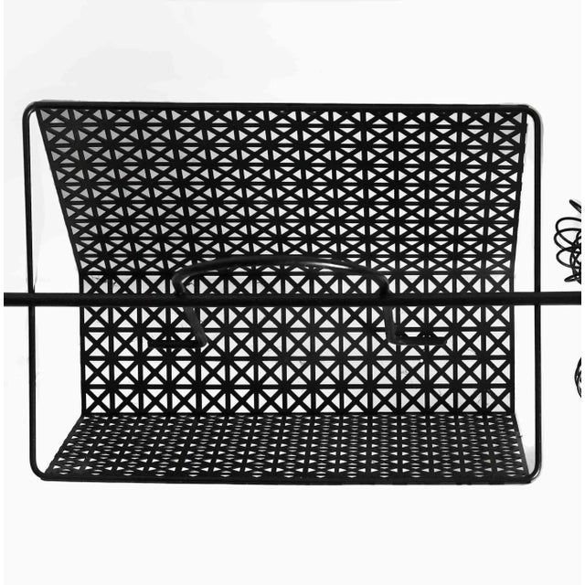 Vintage mid century Frederick Weinberg poodle magazine rack constructed from black iron wire with playful coil detailing...