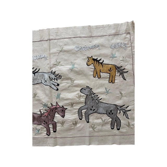 Hand-embroidered Suzani panel from Uzbekistan, worked in fine floss on a natural linen ground. Ten horses in mixed colours...