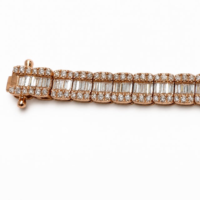 Designed as a statement for the wrist, this 10K Rose Gold bracelet combines round and baguette-cut natural diamonds with a...