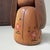 Elegant vintage sōsaku kokeshi by Takeda Daisuke, with a soft natural wood tone and a calm, refined presence. The doll has...