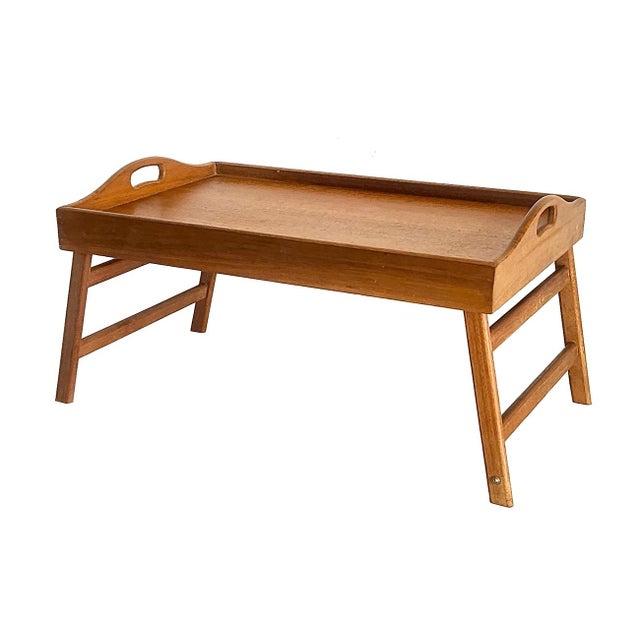 Offered is a vintage 1970s Teak Wood folding tray with handles. Ideal for breakfast in bed, serving TV snacks, or working...