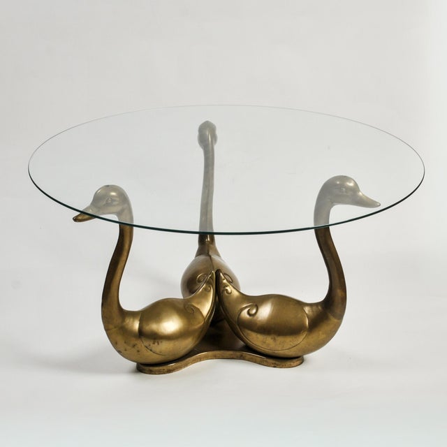 Stunning mid century coffee table in Maison Jansen style Imported by Rosenthal Netter. Three brass swans hold a 34" round...
