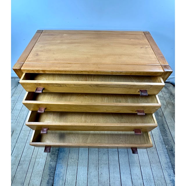 Brutalist chest of drawers in solid elm by Maison Regain, 1970. The front opens to reveal four drawers of varying heights...